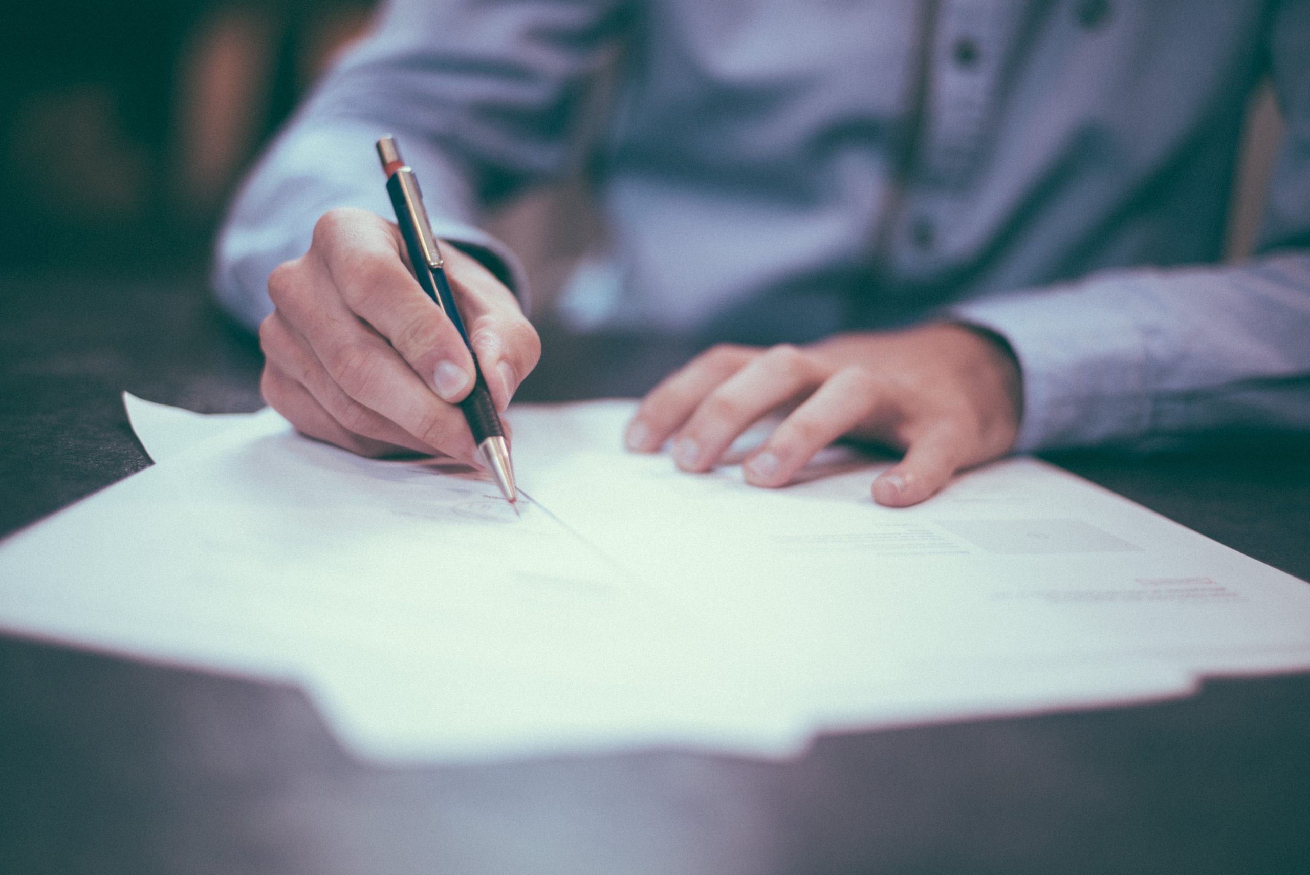 Man filling out paperwork for his visa