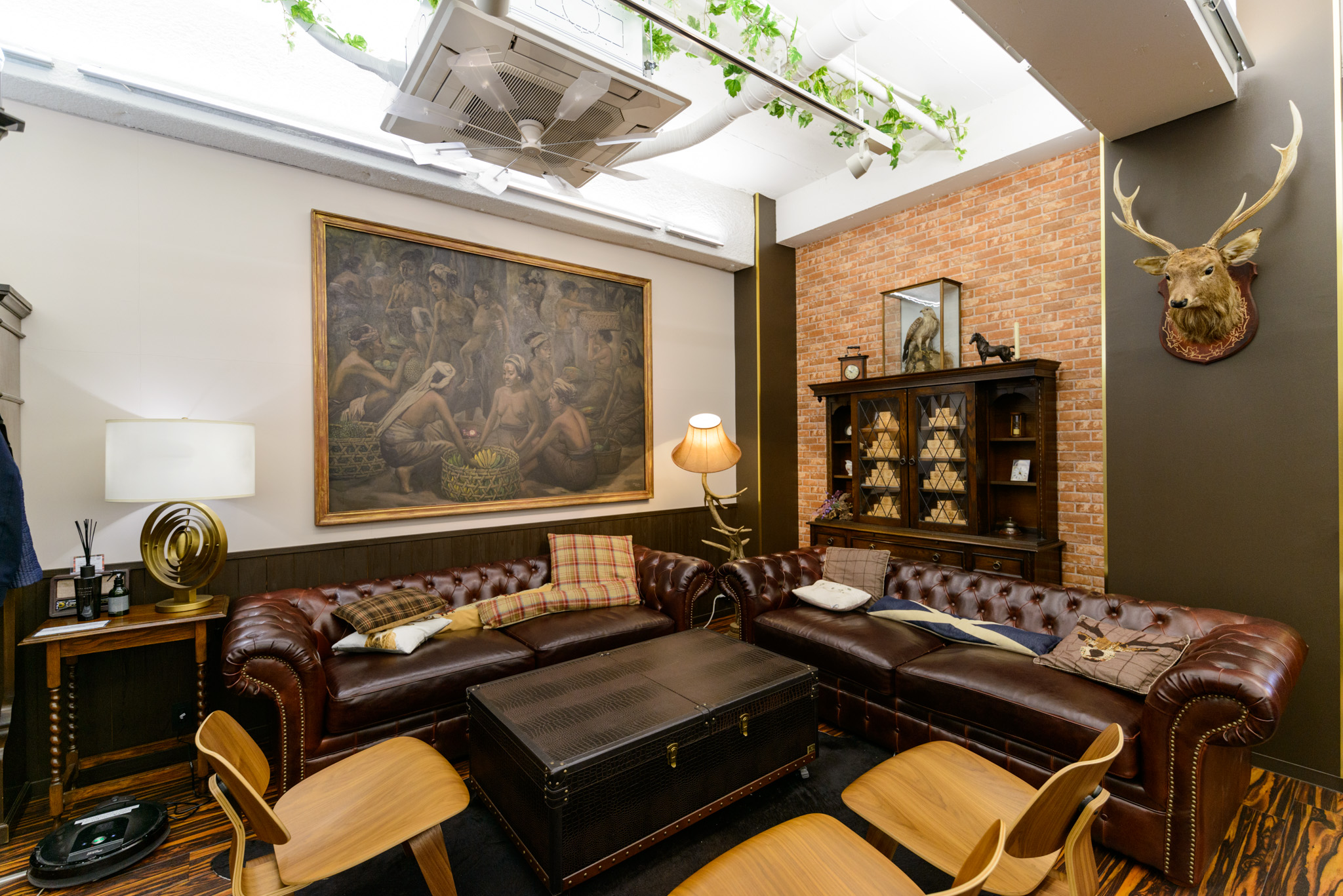 share office with leather couches and paintings on the wall